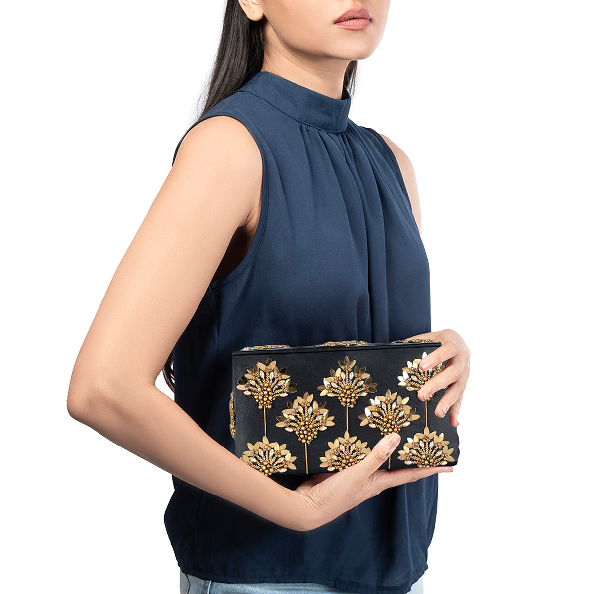 Model carrying Deepa Gurnani Edeline Clutch in Gold color