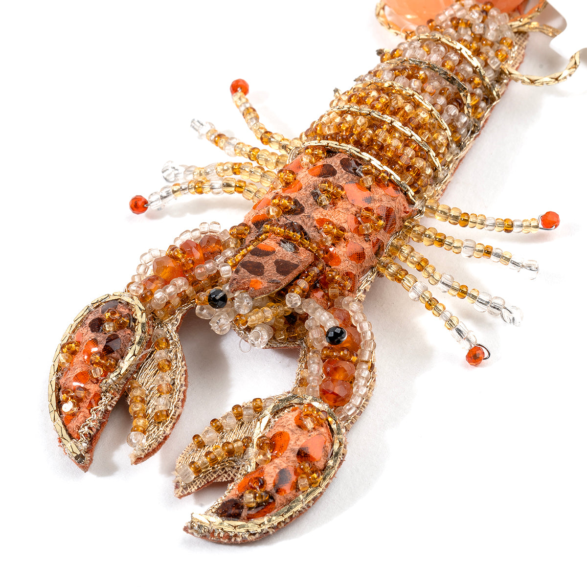 Detail of Deepa Gurnani handmade Lobster brooch in orange color