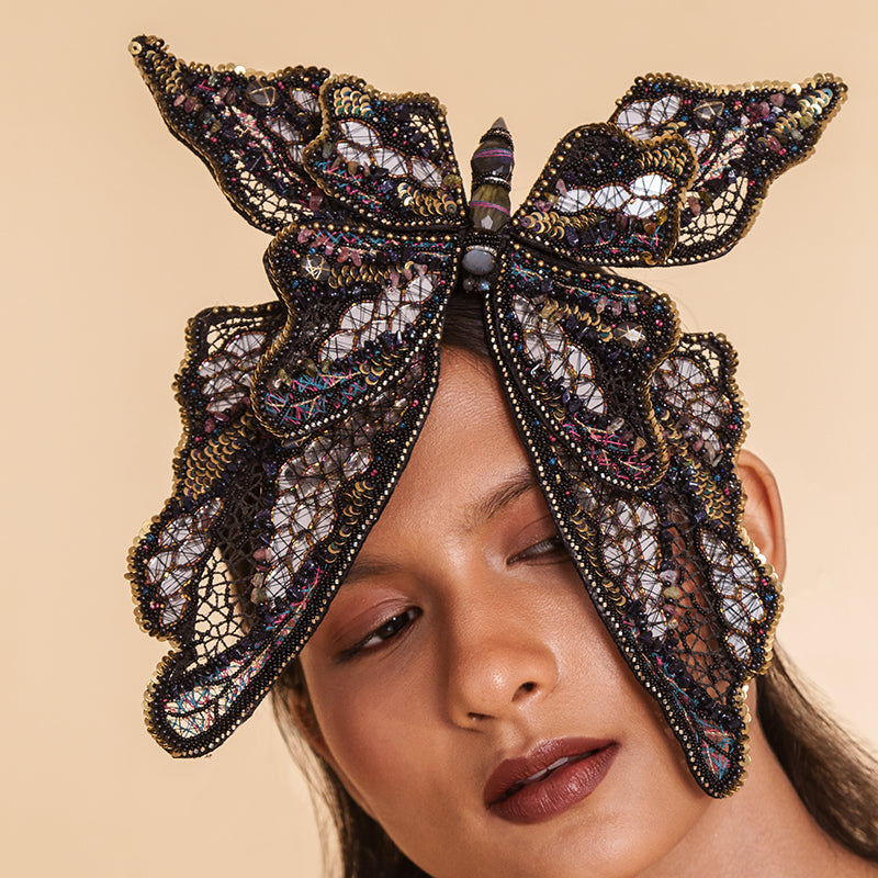 Detail of Model wearing Deepa Gurnani handmade the Monarch headband in black color