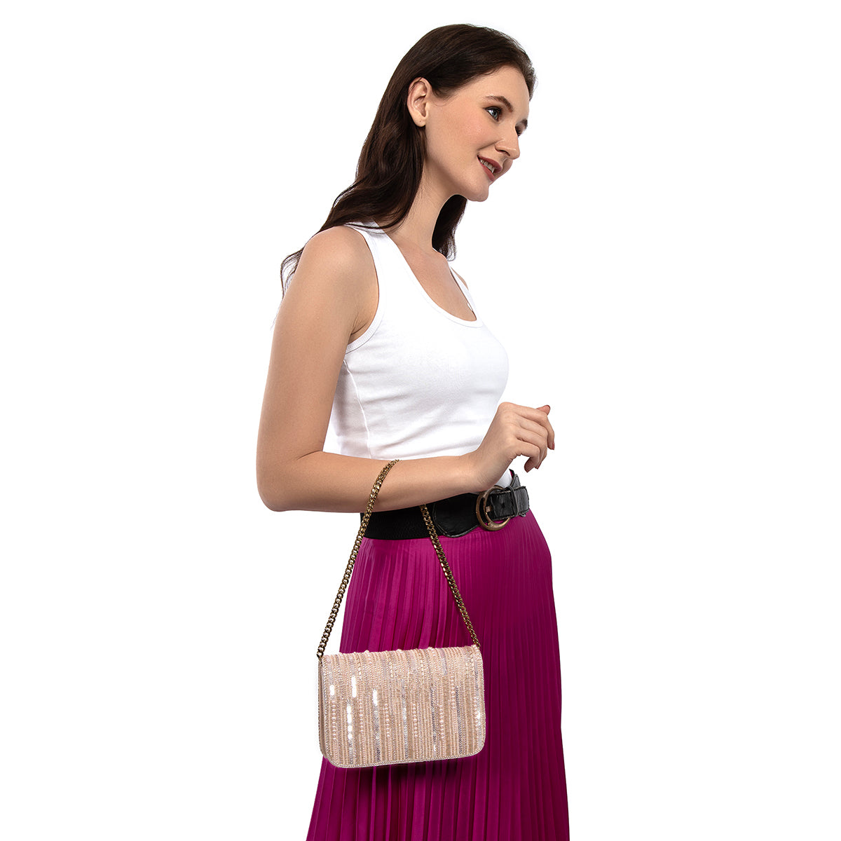 Model carrying Deepa Gurnani Lumina Clutch in peach color