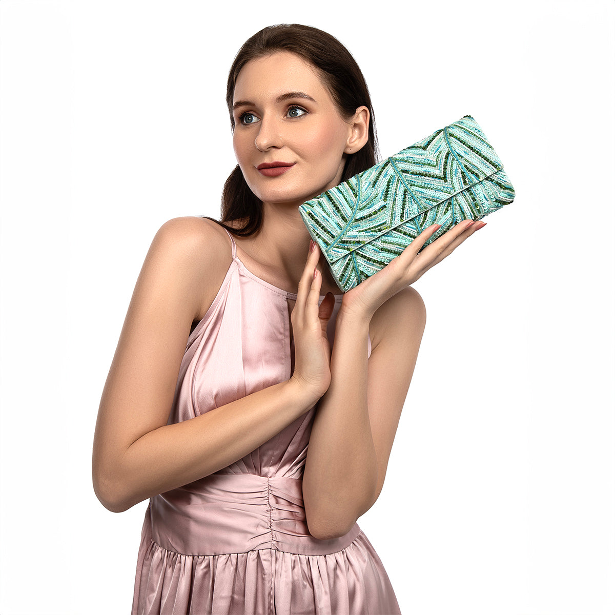 Model carrying Deepa Gurnani Brissa Clutch in aqua color