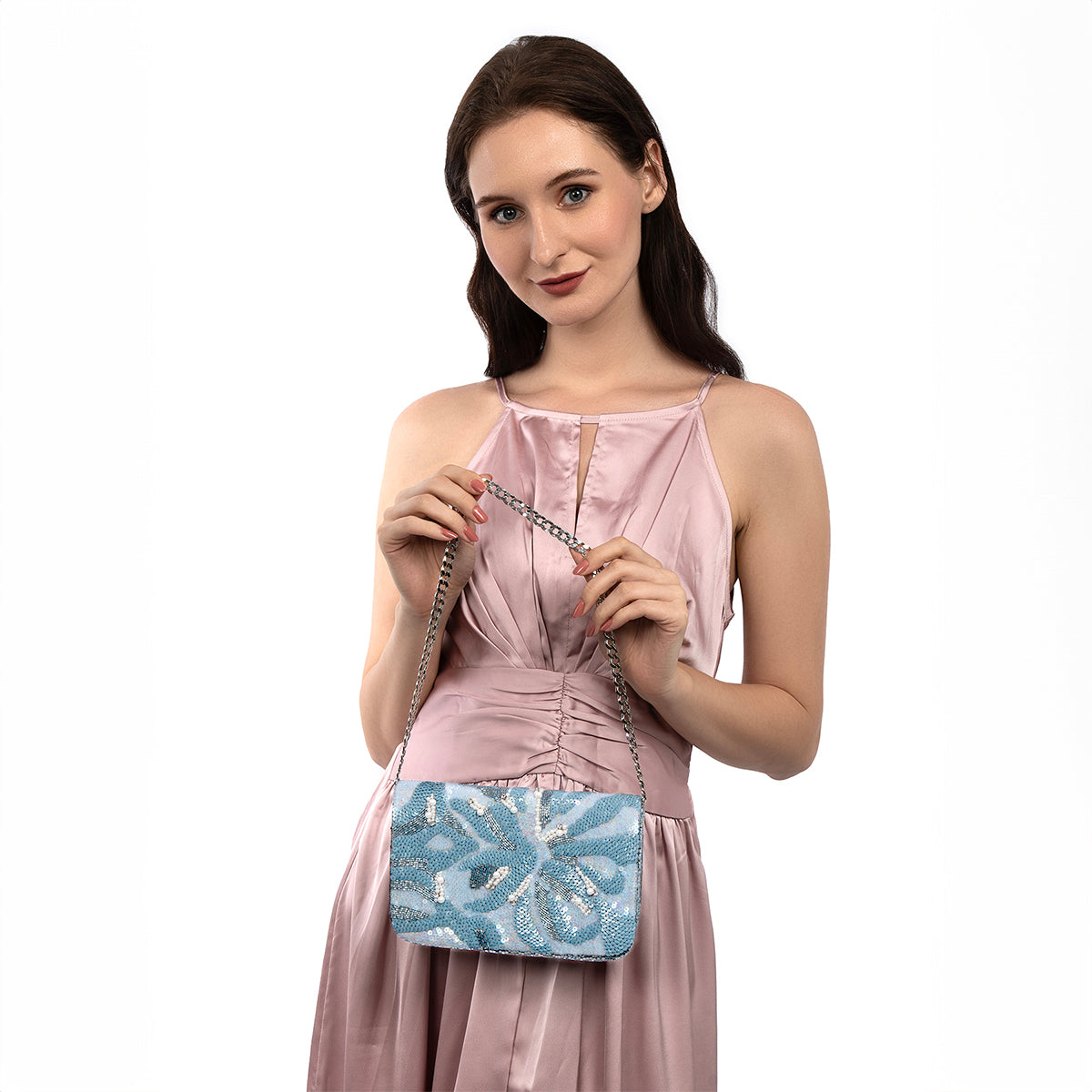 Model carrying Deepa Gurnani Marcella Clutch in powder blue color