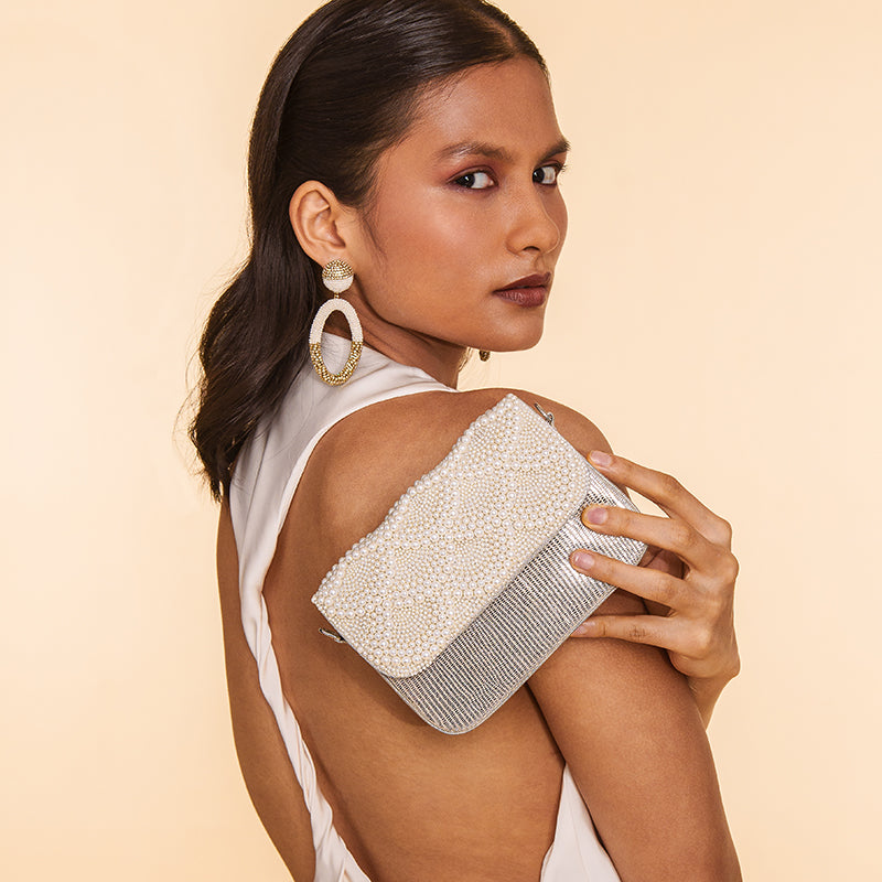 Model Carrying Deepa Gurnani Handmade Sloane clutch in Ivory color