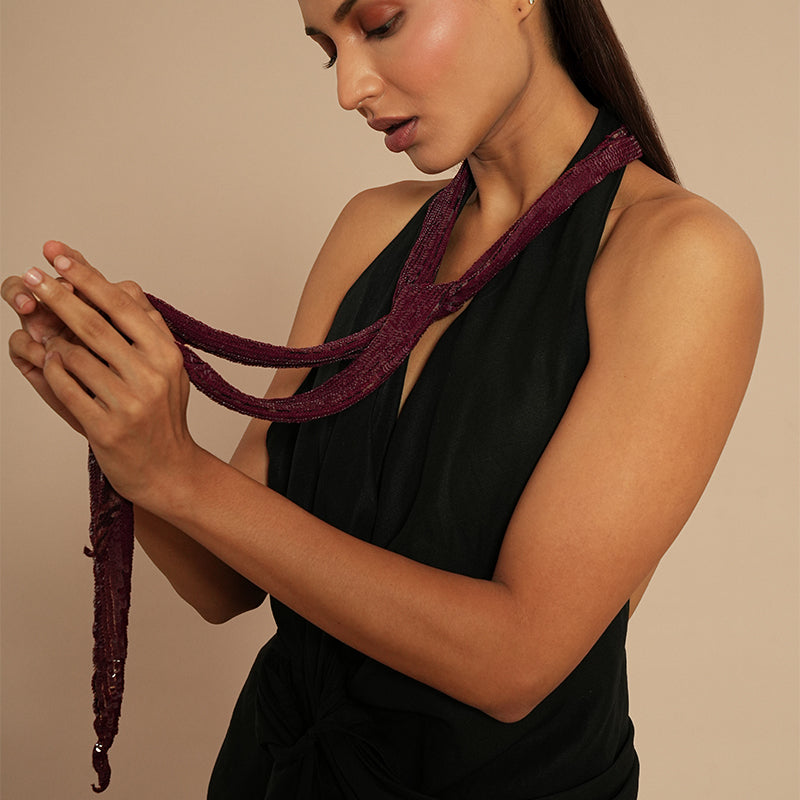 Close up of model wearing Deepa by Deepa Gurnani Veronique Sequin Skinny Scarf in Maroon color