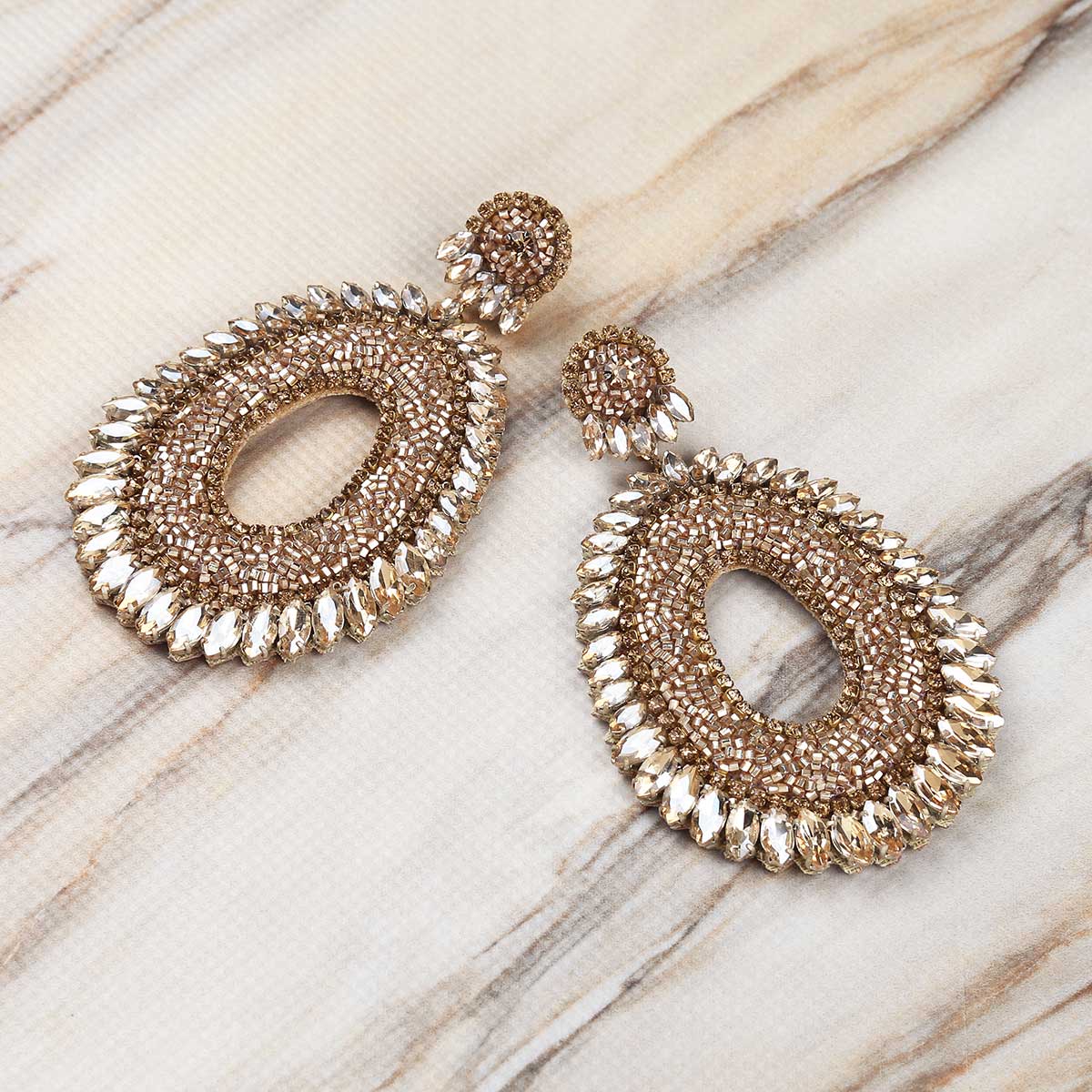 Deepa Gurnani Handmade Kiki Earrings in Gold on Marble Background