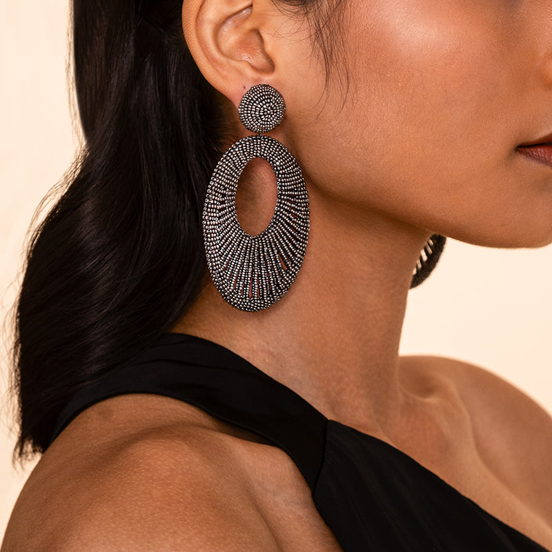 Detail of Model wearing Deepa Gurnani Handmade Cypress Earrings in Gunmetal color