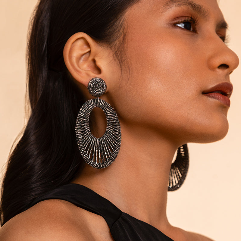 Model wearing Deepa Gurnani Handmade Cypress Earrings in Gunmetal color