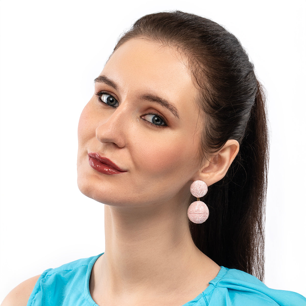 Model wearing Deepa Gurnani handmade the Nica earrings in baby pink color