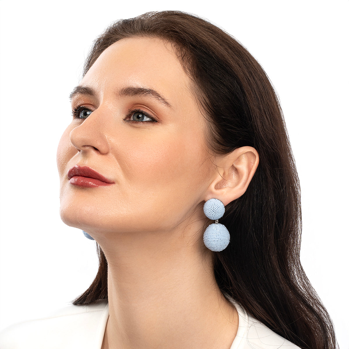 Model wearing Deepa Gurnani handmade the Nica earrings in powder blue color