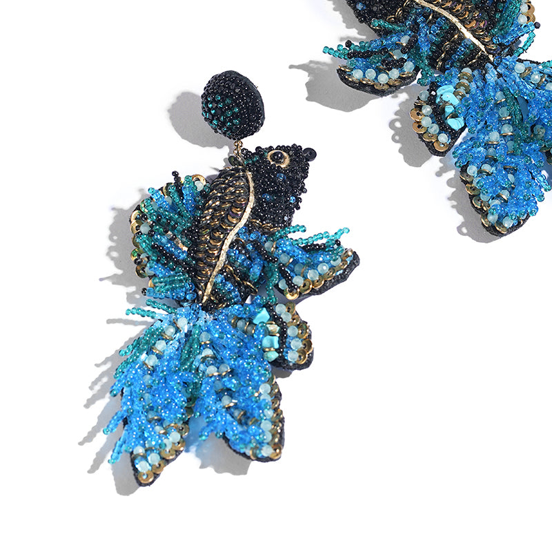 Detail of Deepa Gurnani handmade the Guppy earrings in blue color.