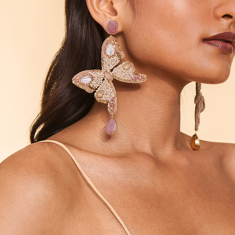 Detail of Model wearing Deepa Gurnani Handmade Ilona Earrings in Beige color