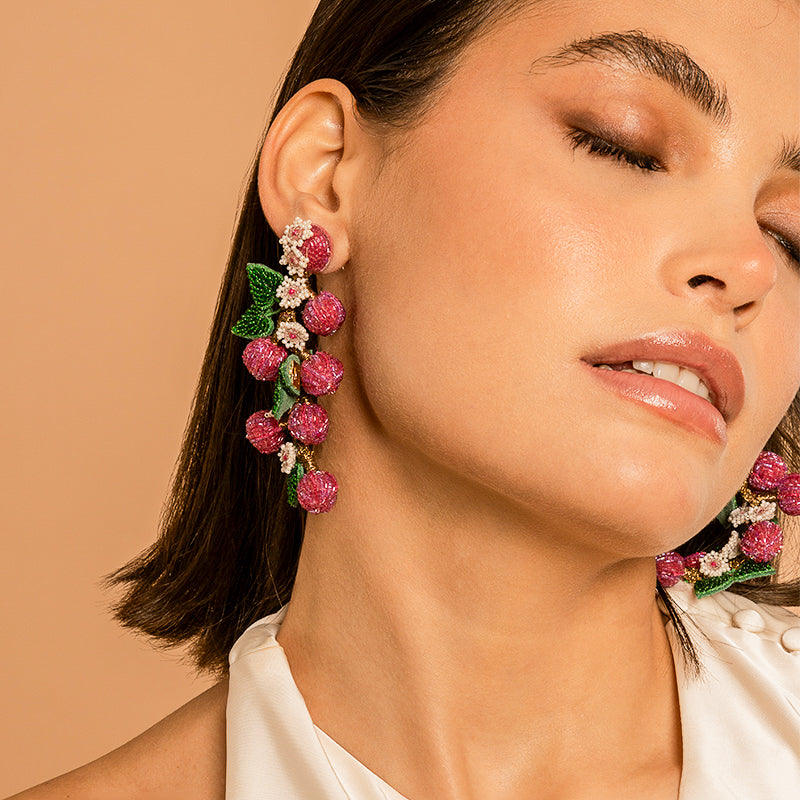 Model Wearing Deepa Gurnani handmade Berries Earrings in Magenta color