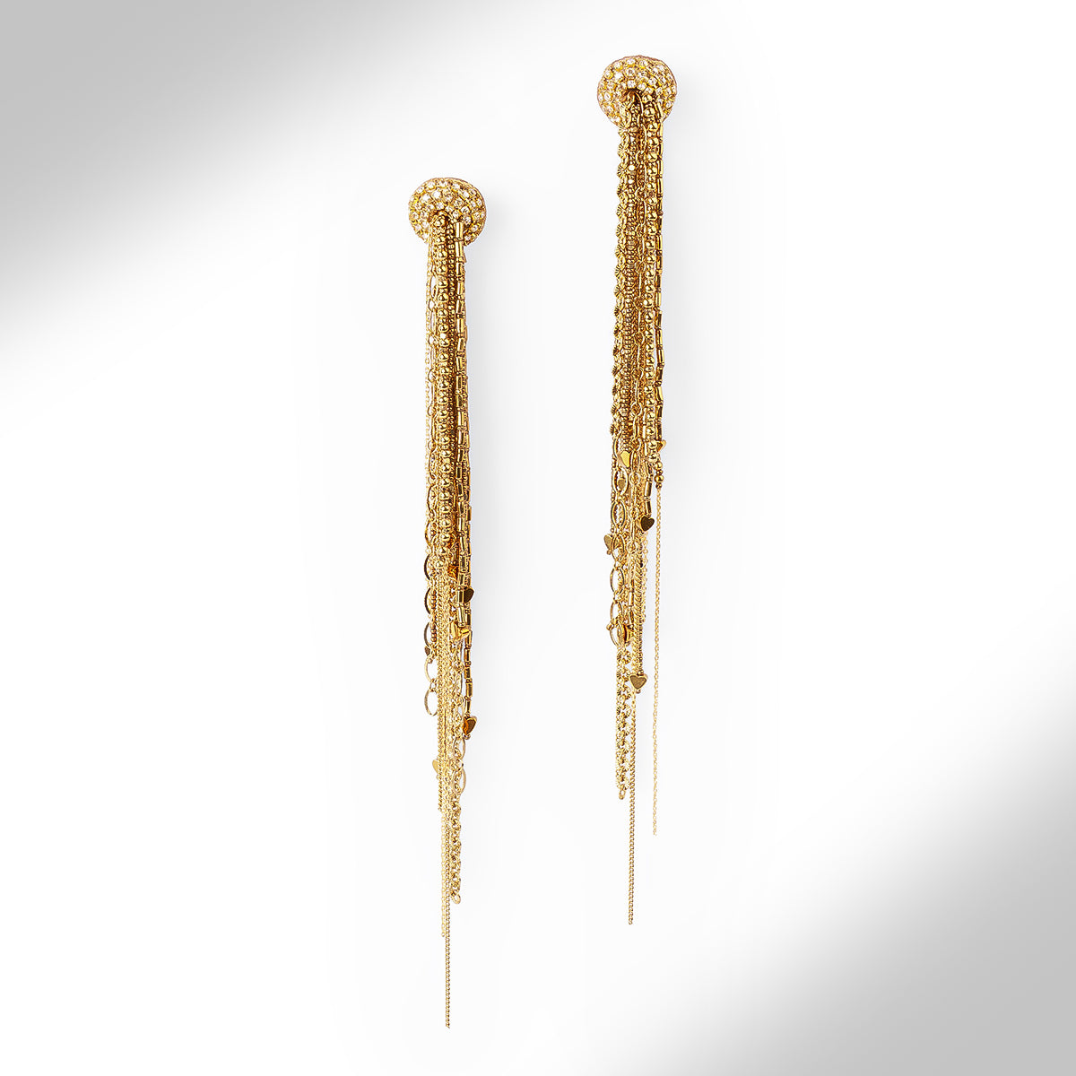 A pair of gold-toned statement dangle earrings with textured circular studs and multiple cascading chain layers, shown against a clean white background with a soft shadow.