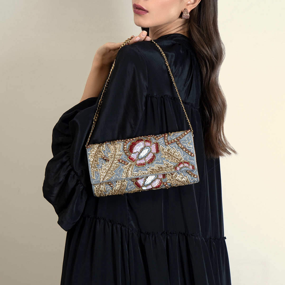 Model carrying Deepa Gurnani Wilder Clutch