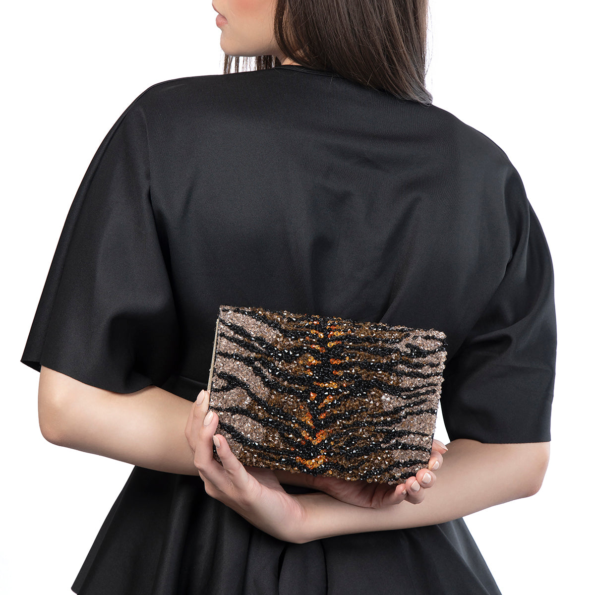 Model carrying Deepa Gurnani Helga Clutch in Brown color