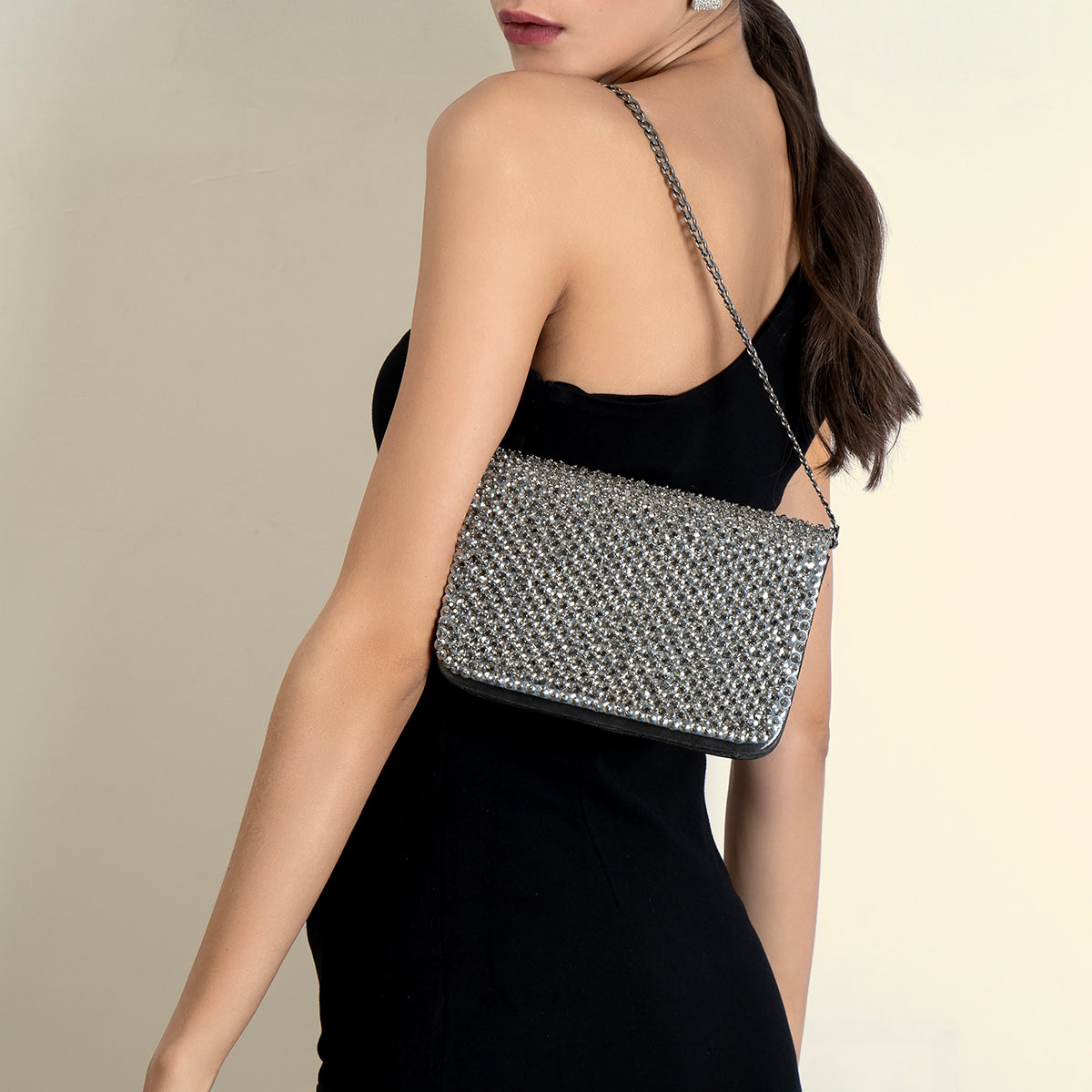 Model carrying Deepa Gurnani Gunmetal Aime Clutch