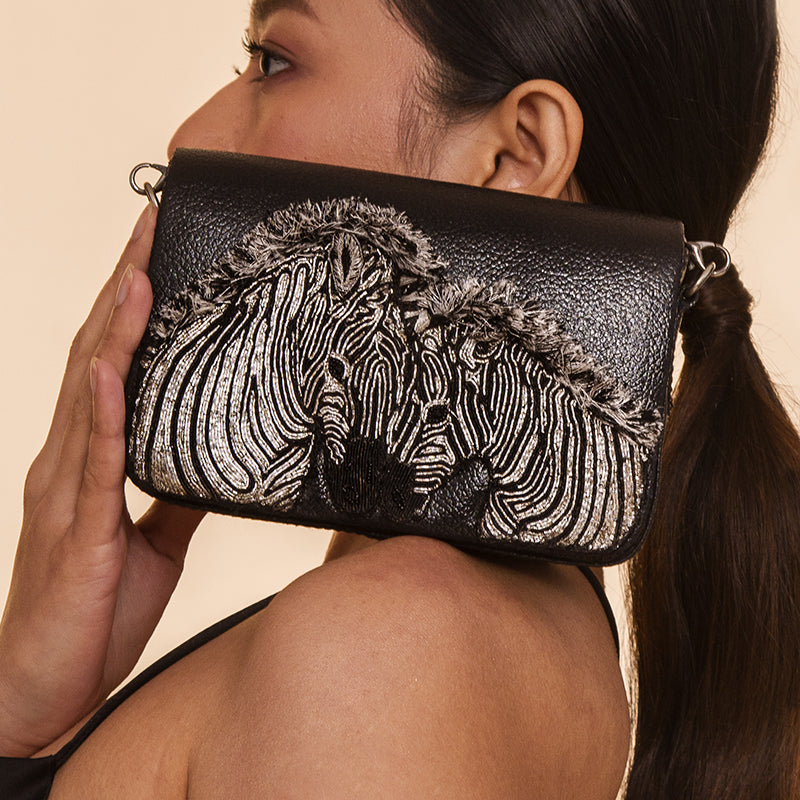 Detail of Model wearing Deepa Gurnani Handmade Zebra clutch in black color