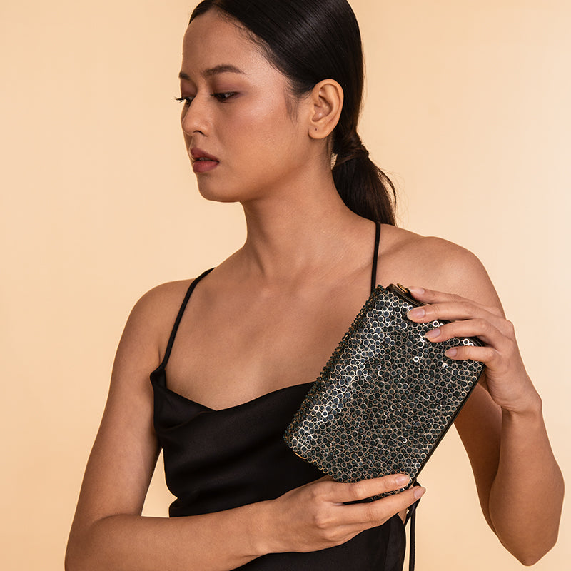 Model carrying Deepa Gurnani Handmade Mason Clutch in Emerald color