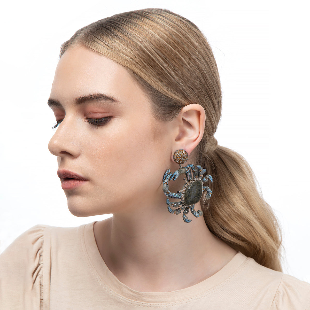 Whimsical crab earrings worn by model