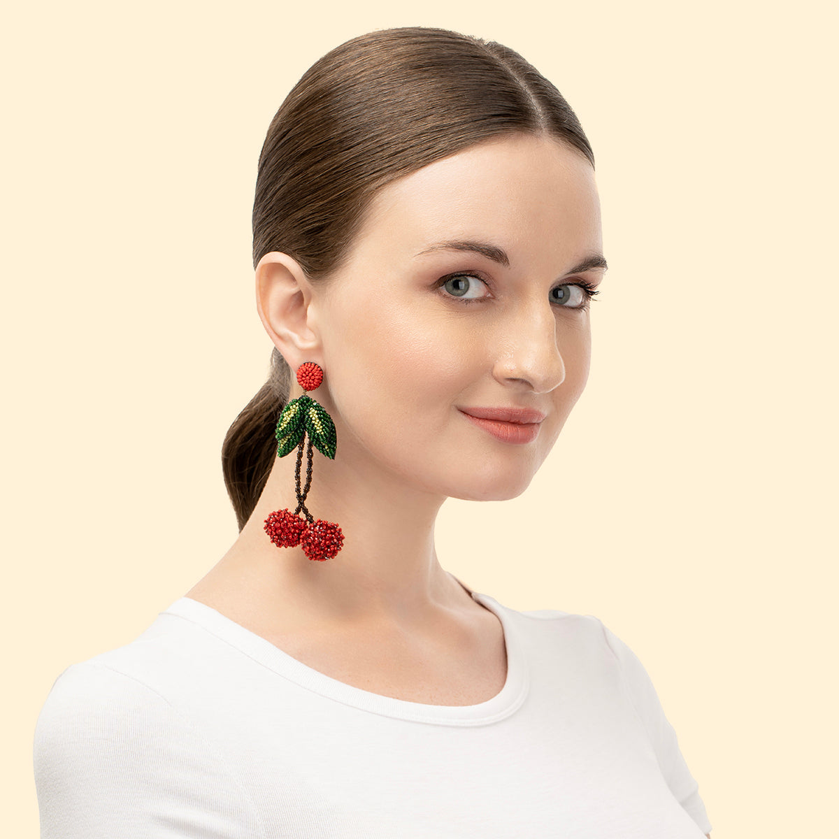 Model wearing handmade lightweight beaded Cherry Earrings