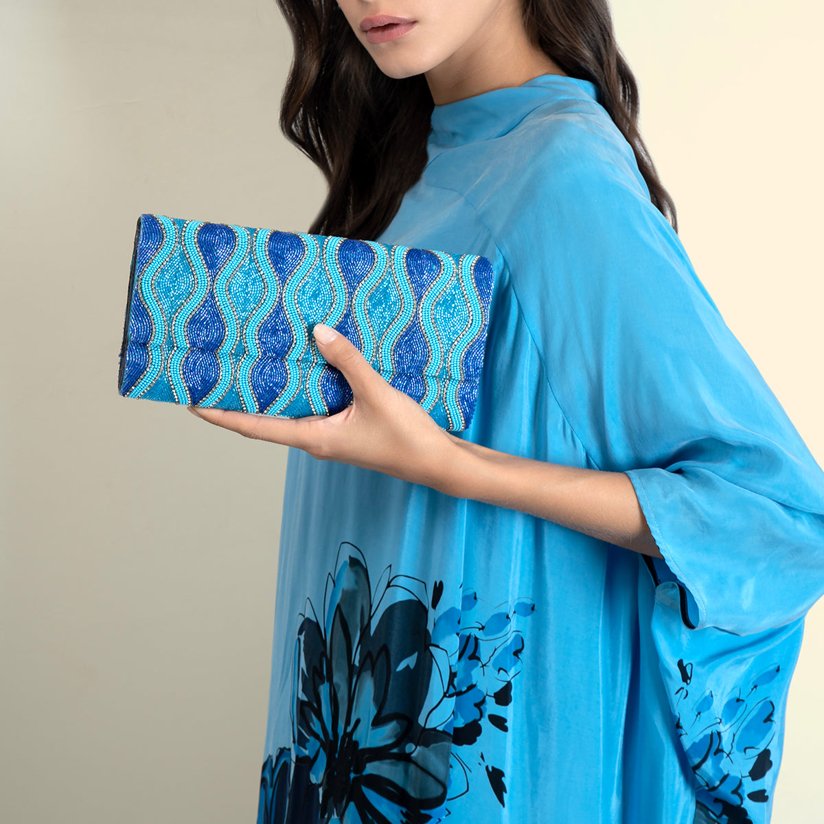 Model carrying Deepa Gurnani Turquoise Violetta Clutch