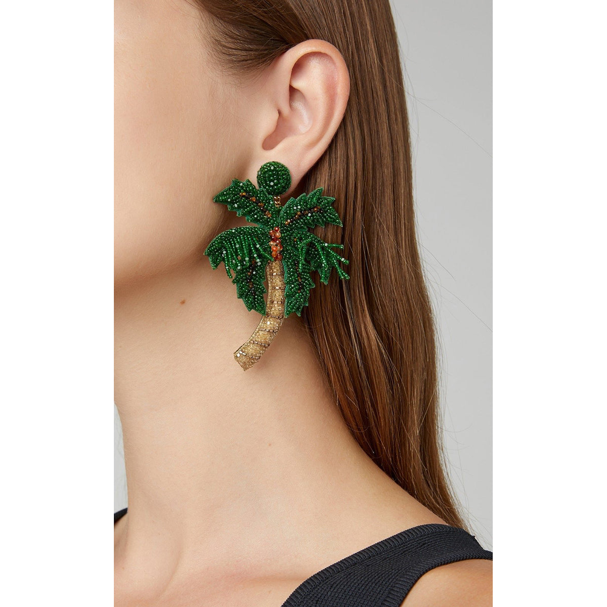 Palm tree earrings worn by model