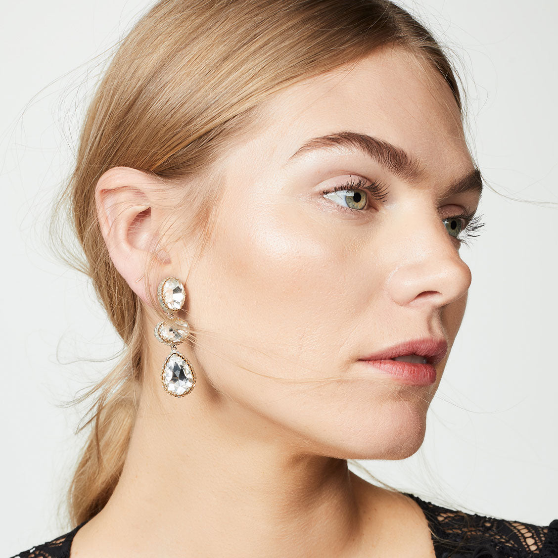 Model wearing silver three crystal handmade post earrings